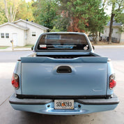 Oracal Gloss Dove Blue Metallic pickup truck parked on a residential street with trees and houses 