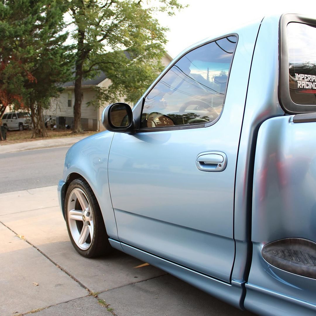 Oracal Gloss Dove Blue Metallic car parked on a street with trees and houses