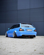 Rear view of Oracal Gloss Glacier Blue installed on a car parked in front of a blue metallic wall