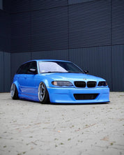 Oracal Gloss Glacier Blue installed on a BMW car parked in front of a dark metallic wall