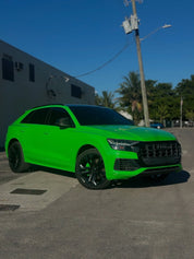 Oracal Gloss Grass Green Audi SUV parked on a street with a clear blue sky