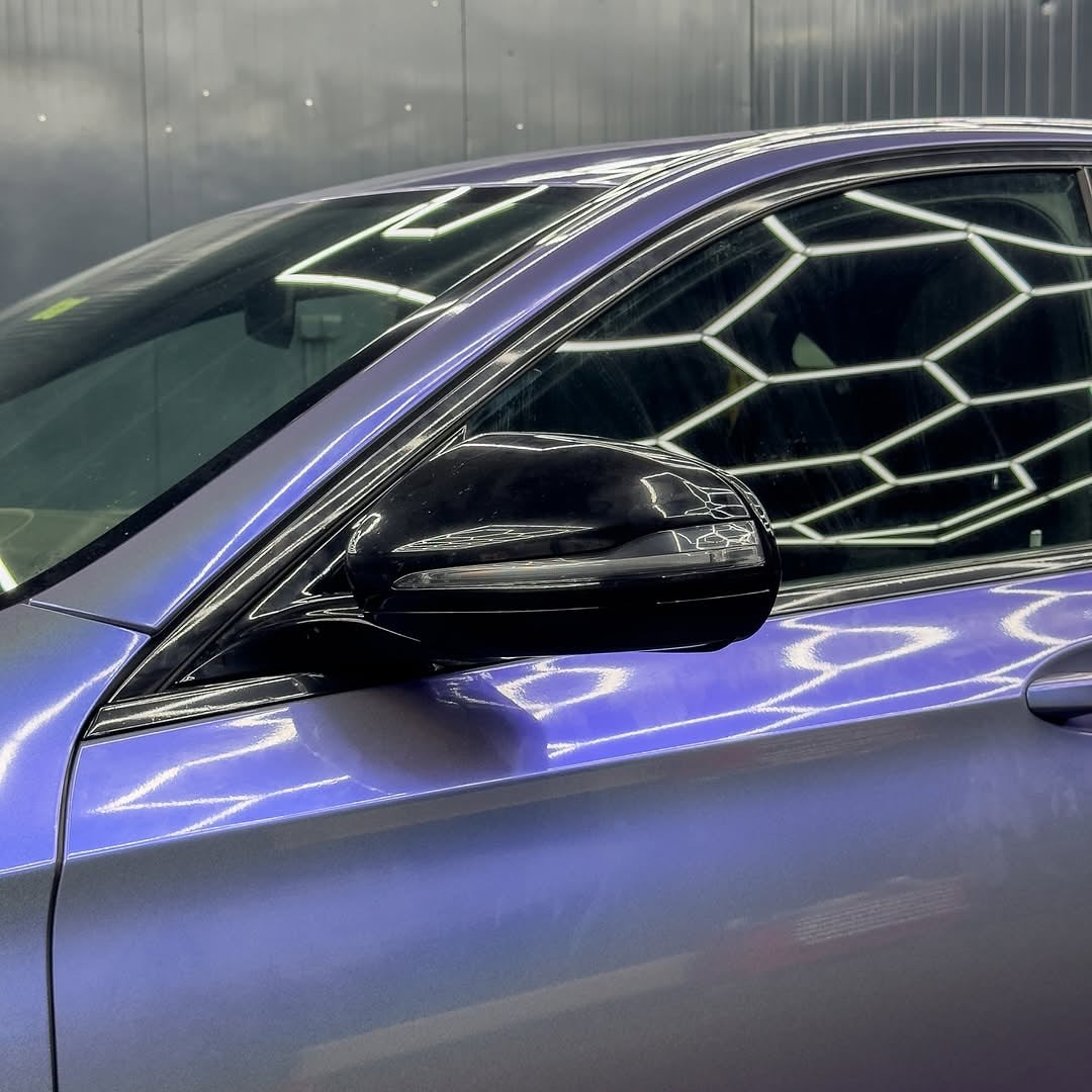 Close-up of a car's side mirror with Gloss Intergalactic Blue installed