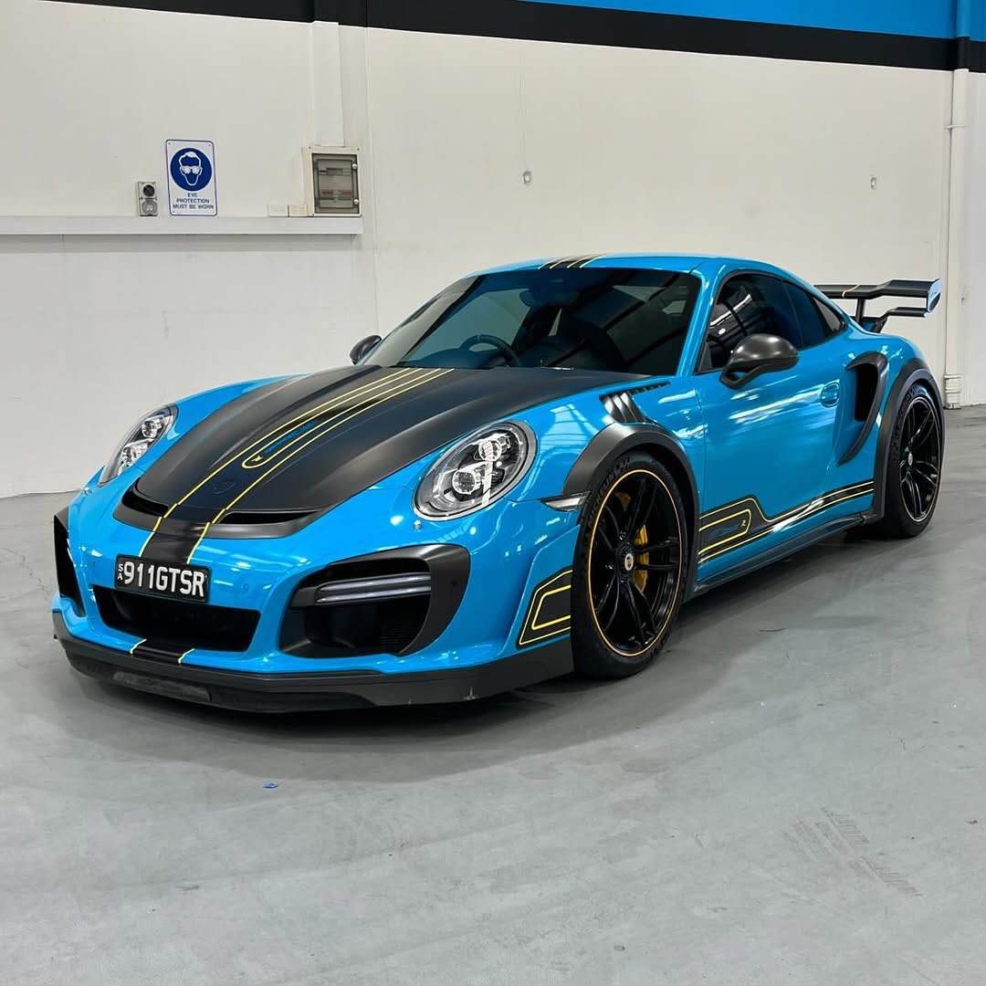 Sports car with Oracal Gloss Lagoon installed in a garage setting