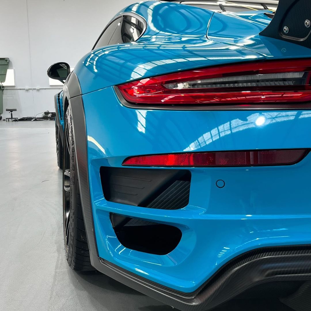 Close-up of an Oracal Gloss Lagoon car's rear end in a showroom