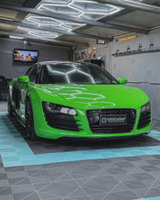Oracal Gloss Lawn Green wrap on a sports car, parked in a garage