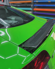 Close-up of an Oracal Gloss Lawn Green wrap on a car's rear end with a colorful tool chest