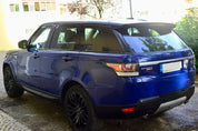 Oracal Gloss Light Navy Range Rover parked on a driveway with a building and trees