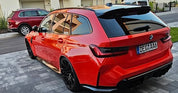Rear view of Oracal Gloss Light Red installed on a BMW car parked on a driveway