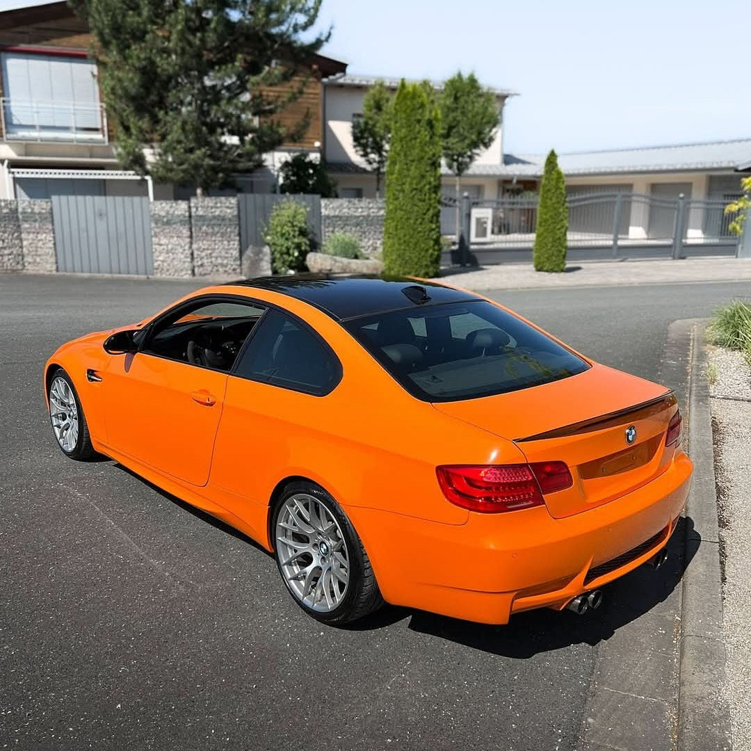 Oracal Gloss Municipal Orange on a  BMW car parked on a residential street