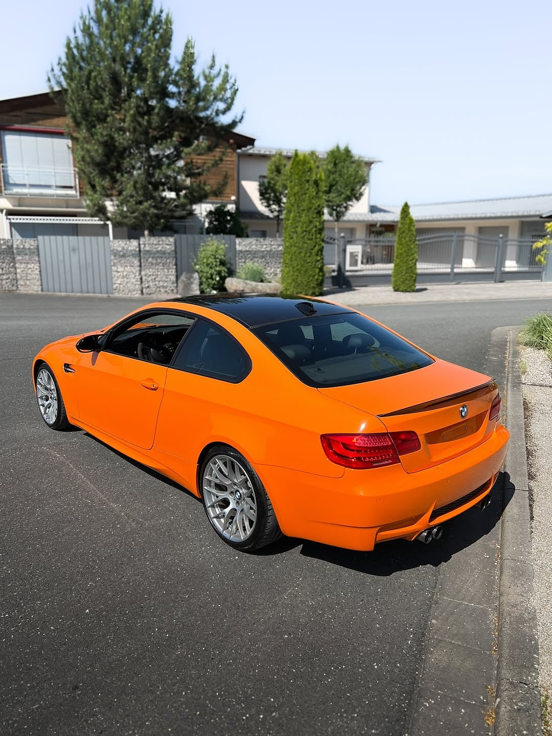 Oracal Gloss Municipal Orange on a  BMW car parked on a residential street