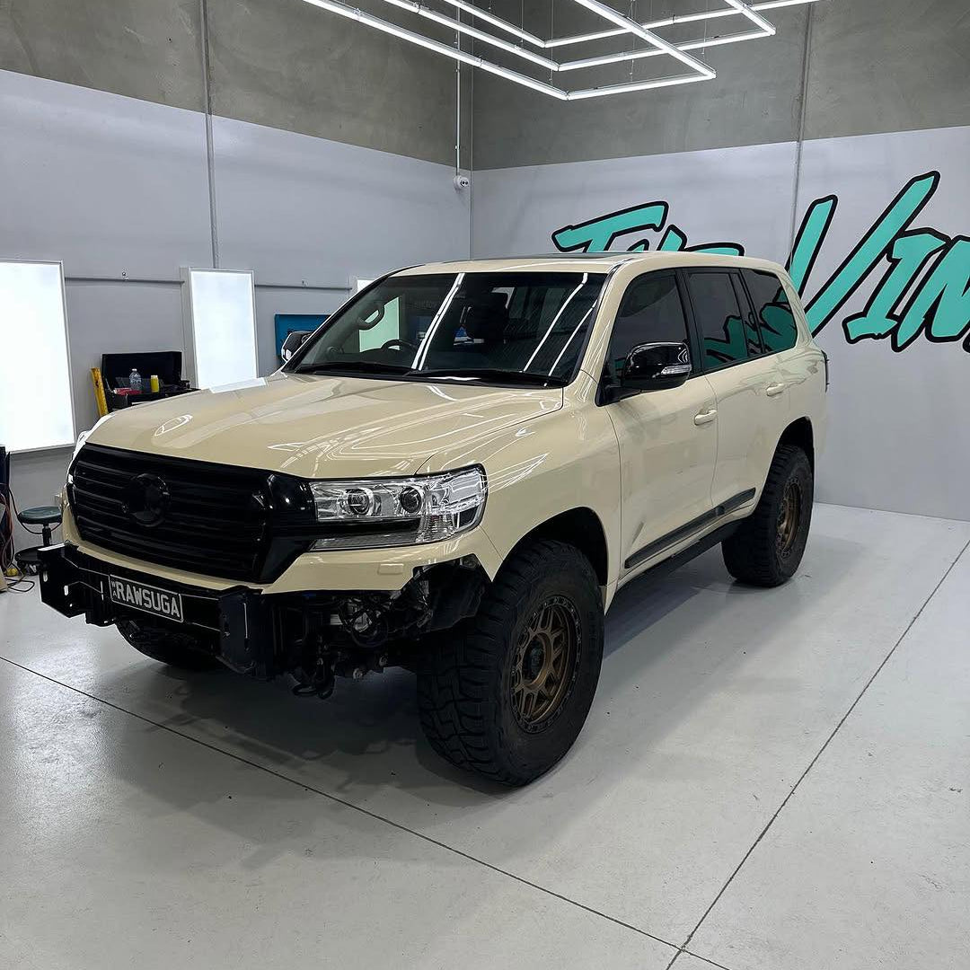 Oracal Gloss Papyrus SUV in a showroom with a brand logo on the wall