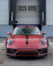Oracal Gloss Red Brown Metallic installed on a Porsche car parked in front of a garage door