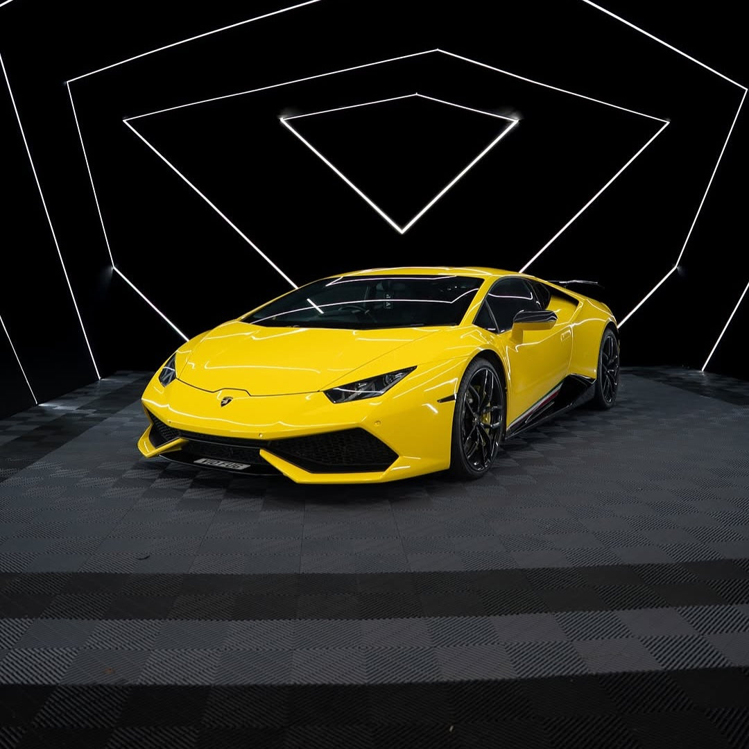 Oracal Gloss Traffic Yellow on Lamborghini with a black checkered floor with geometric light design