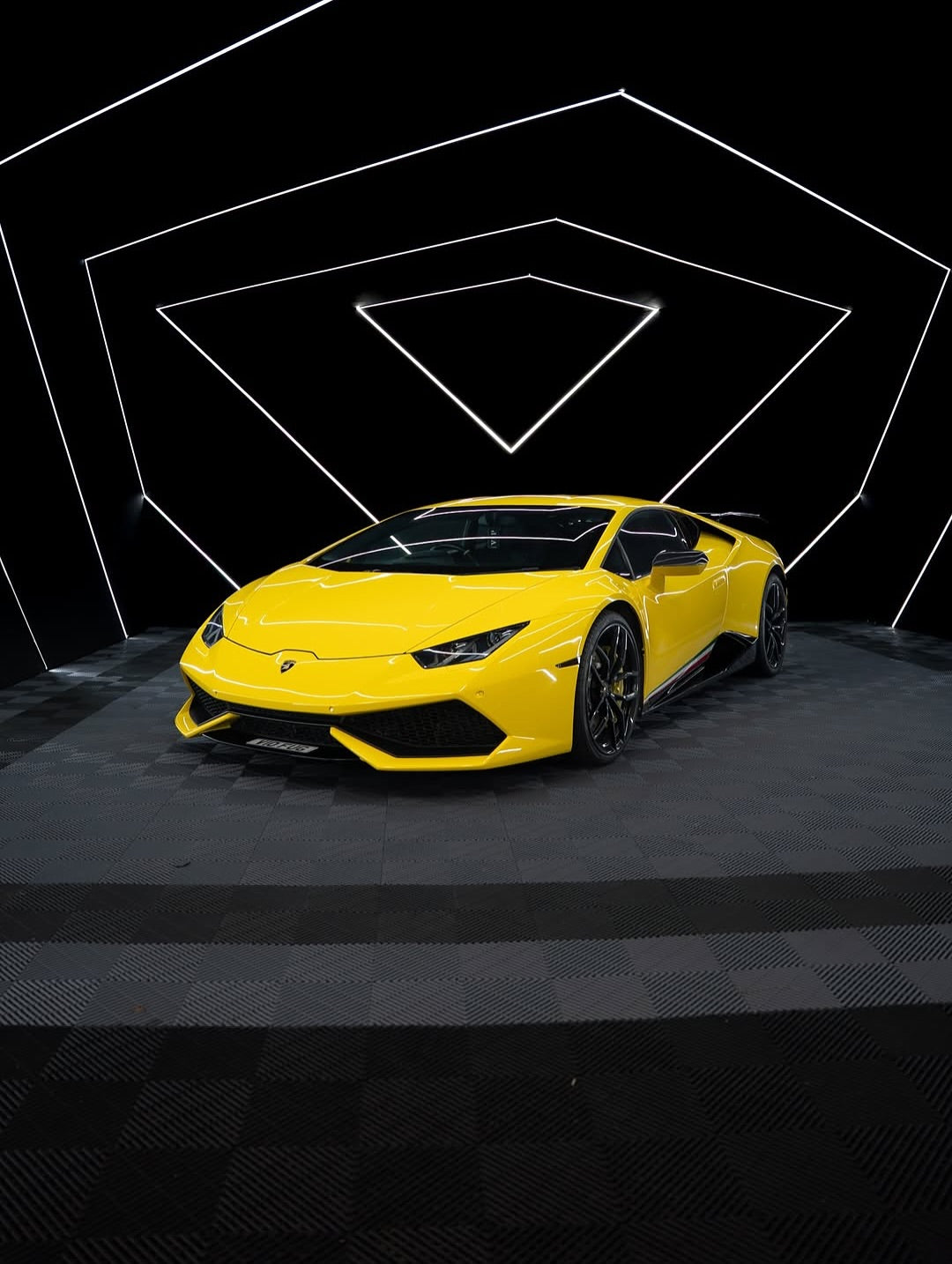 Oracal Gloss Traffic Yellow on Lamborghini with a black checkered floor with geometric light design