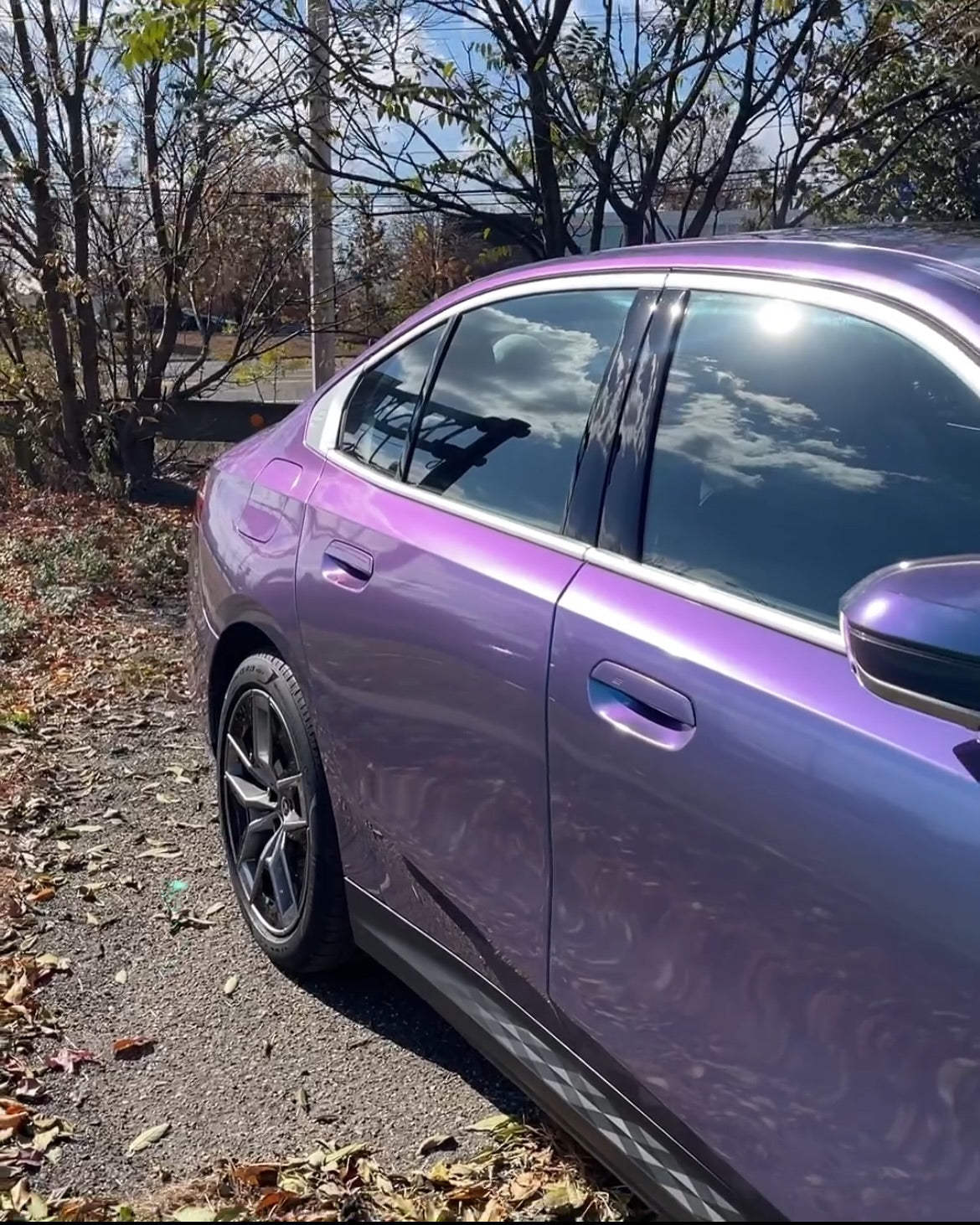 Oracal Gloss Turquoise Lavender car parked on a gravel road with trees and sky