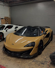 Oracal Gloss Turquoise Lavender sports car parked in a warehouse with a white car