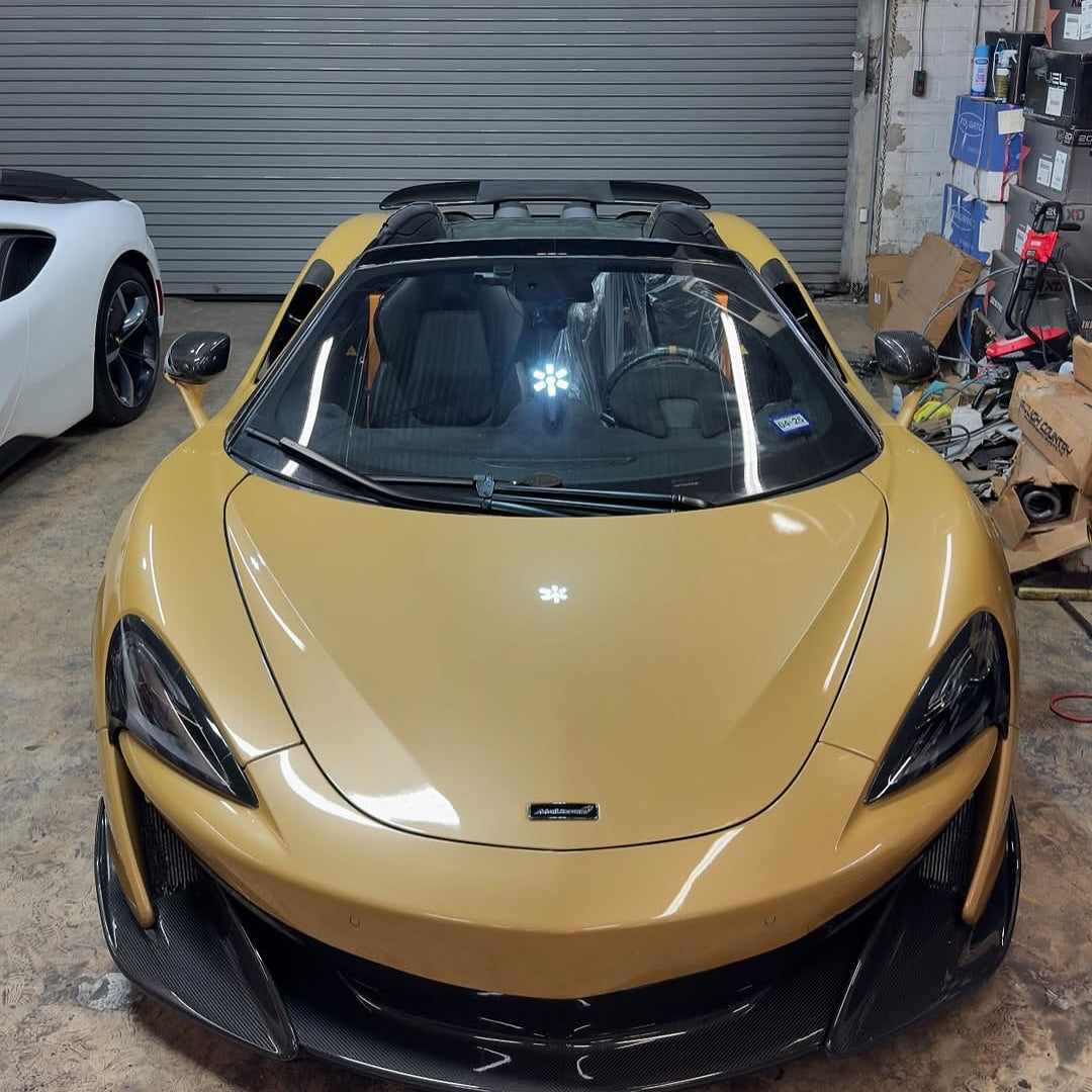 Oracal Gloss Turquoise Lavender sports car in a garage with a white car partially visible