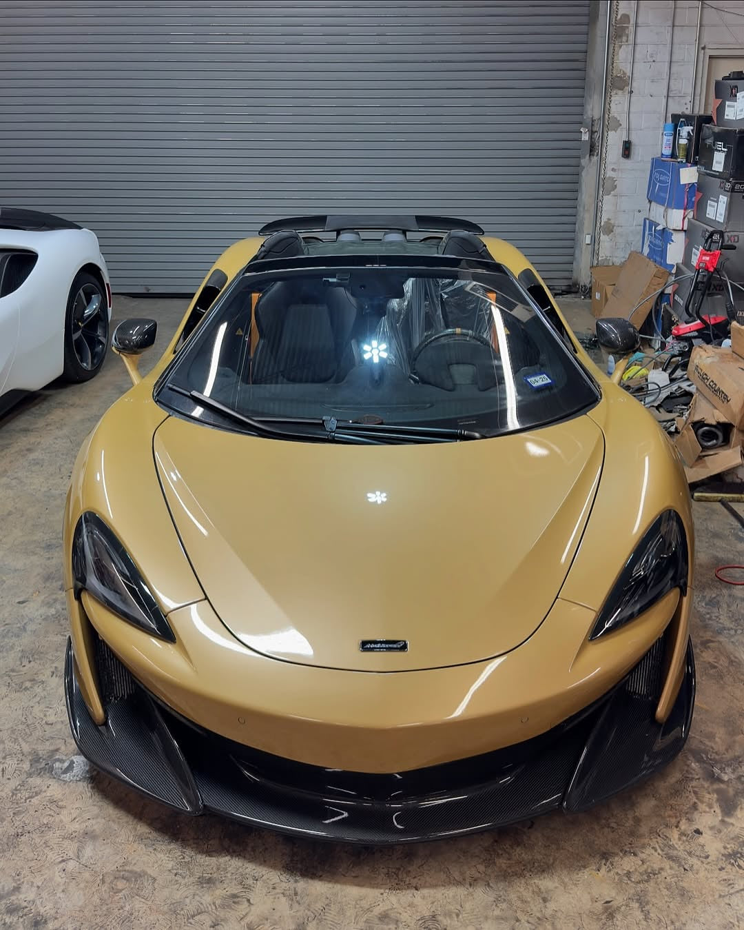Oracal Gloss Turquoise Lavender sports car in a garage with a white car partially visible