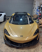 Oracal Gloss Turquoise Lavender sports car in a garage with a white car partially visible