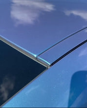 Close-up of an Oracal Gloss Turquoise Lavender car's roof with a clear sky reflection
