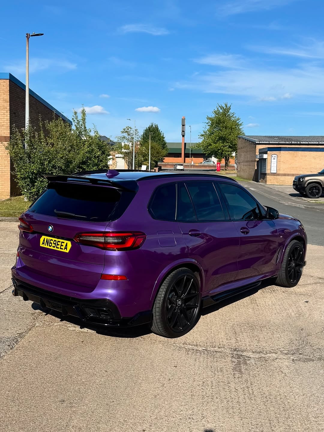 Oracal Gloss Violet Metallic wrap on an SUV, parked on a street with a clear blue sky