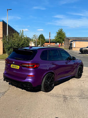 Oracal Gloss Violet Metallic wrap on an SUV, parked on a street with a clear blue sky