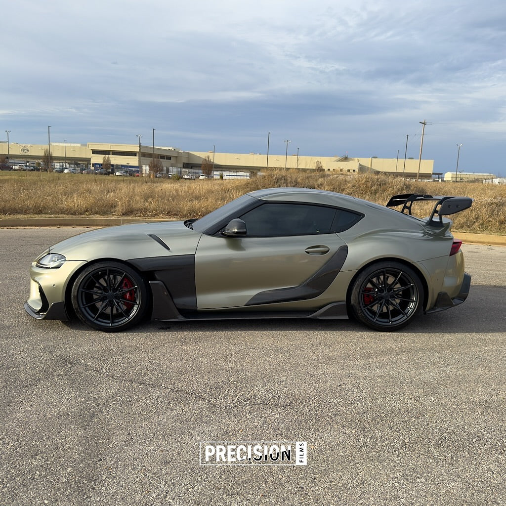 A car on a road with Oracal Gloss Zinc Metallic installed is parked on a building