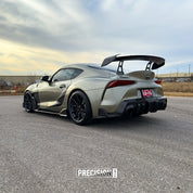 Oracal Gloss Zinc Metallic car with a large rear wing on a road