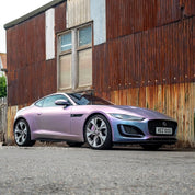 Oracal Matte Amethyst on a sports car, parked in front of a rustic building