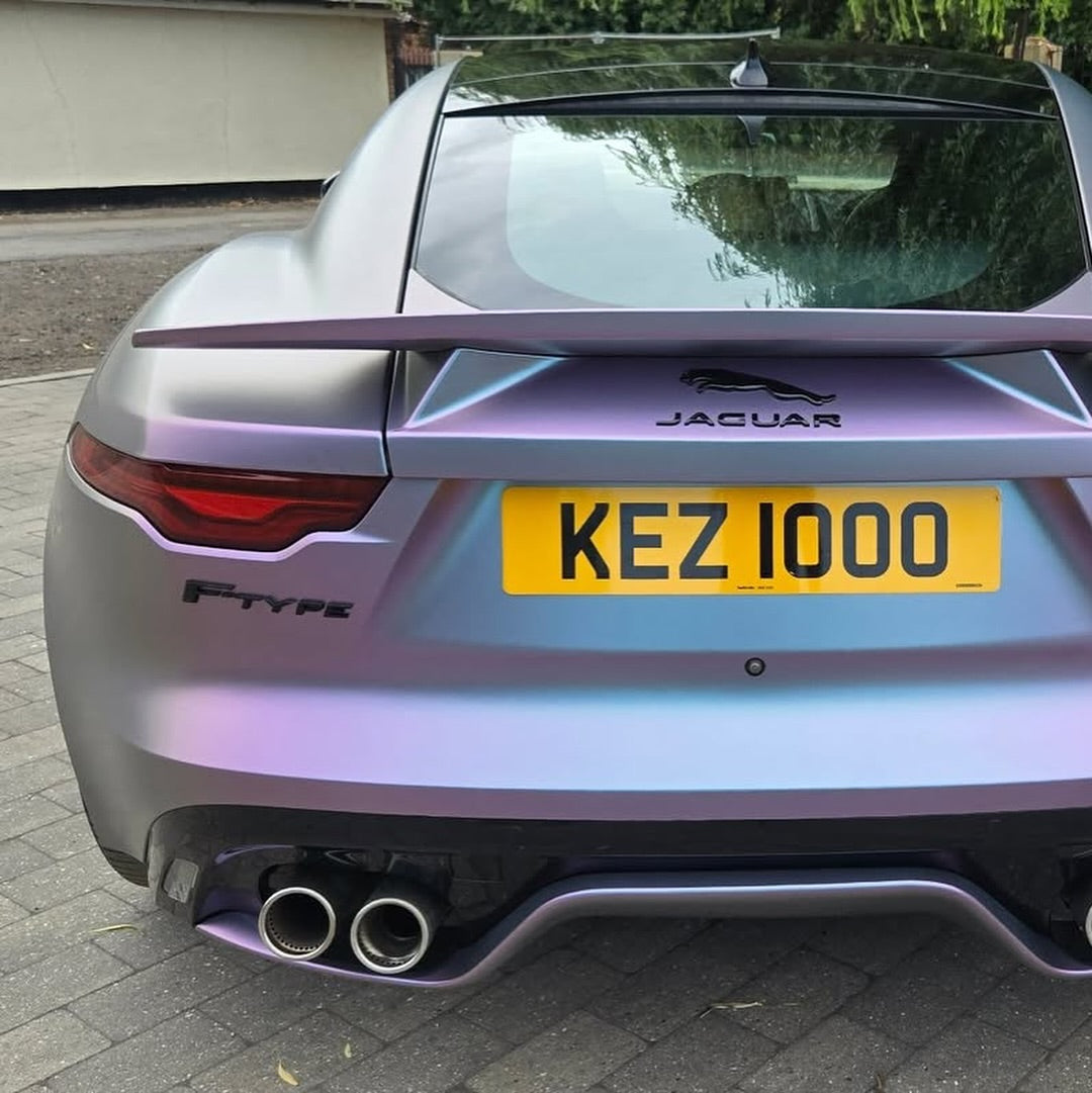 Jaguar F-Type car with Oracal Matte Amethyst wrap, parked on a driveway.