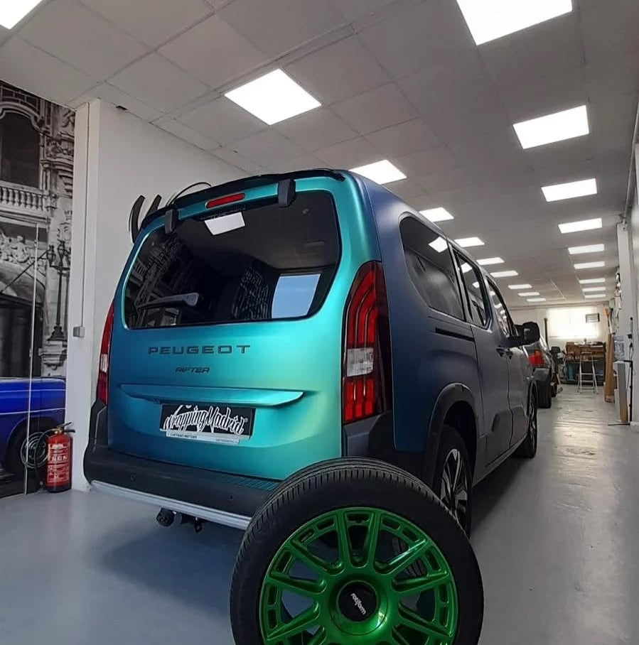 Oracal Matte Aquamarine car parked in a showroom