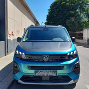 Oracal Matte Aquamarine SUV parked on a street with a building and trees 