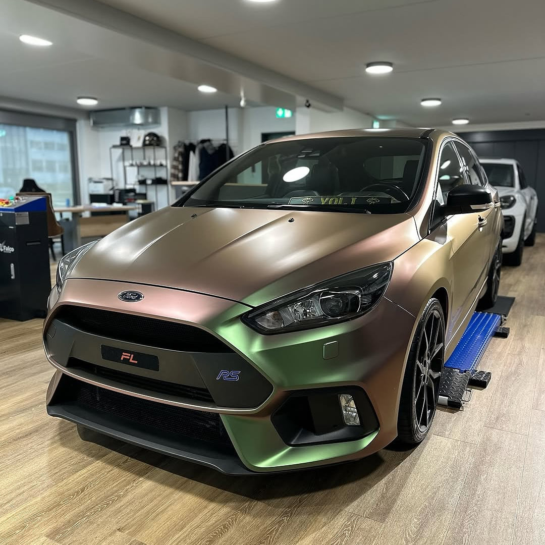 Oracal Matte Avocado car on display in a showroom with wooden flooring