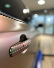 Close-up of a car door handle with Oracal Matte Avocado installed