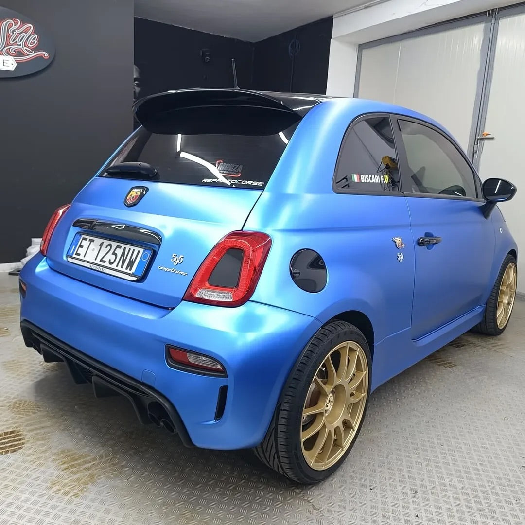 Oracal Matte Azure Blue Metallic car with gold wheels in a garage
