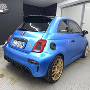 Oracal Matte Azure Blue Metallic car with gold wheels in a garage