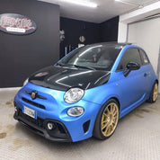 Oracal Matte Azure Blue Metallic car with gold wheels in a garage