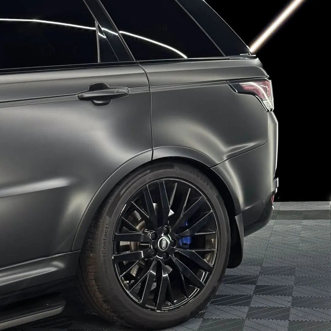 Oracal Matte Black installed on SUV with black wheels on a checkered floor