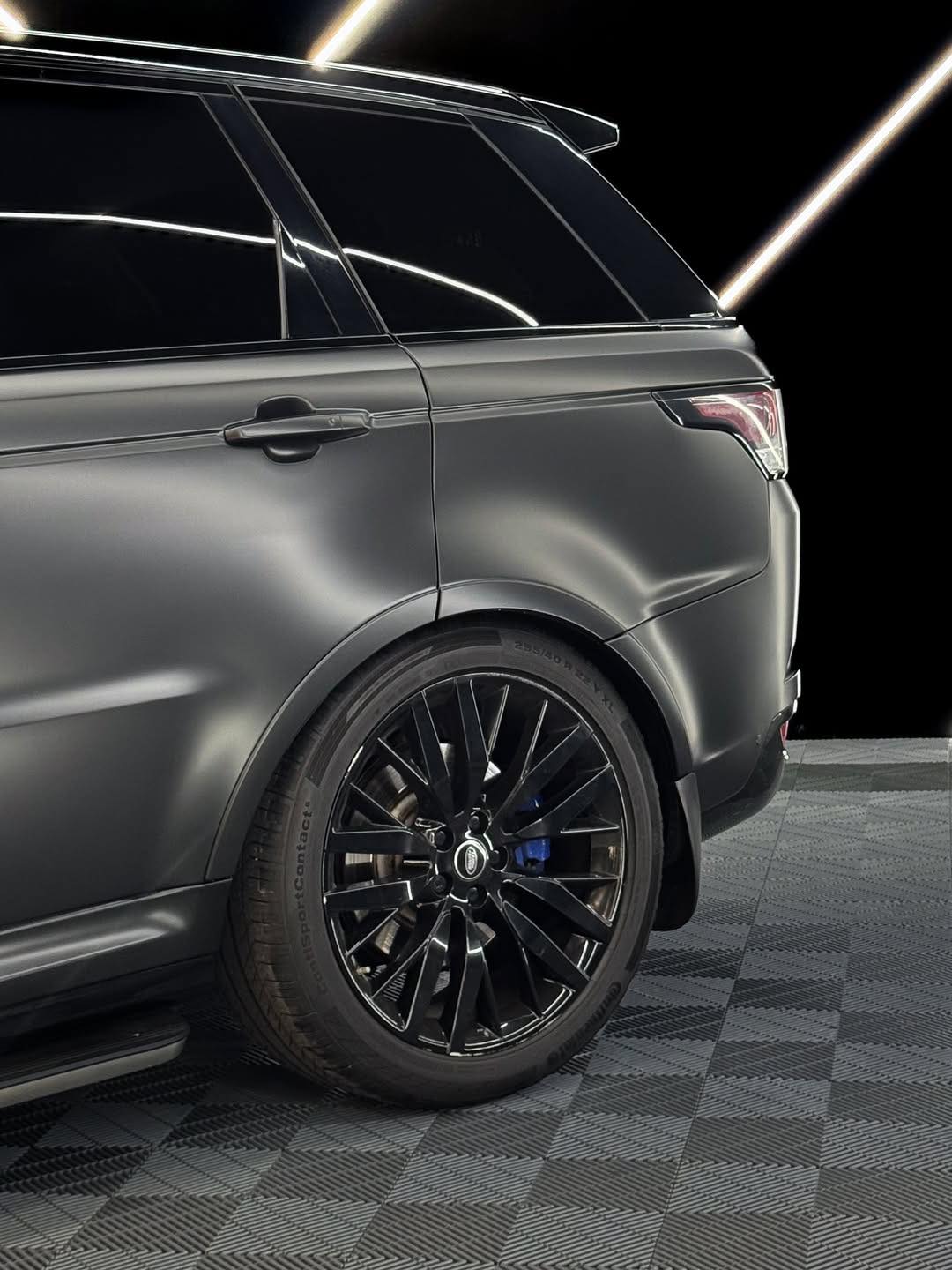 Oracal Matte Black installed on SUV with black wheels on a checkered floor