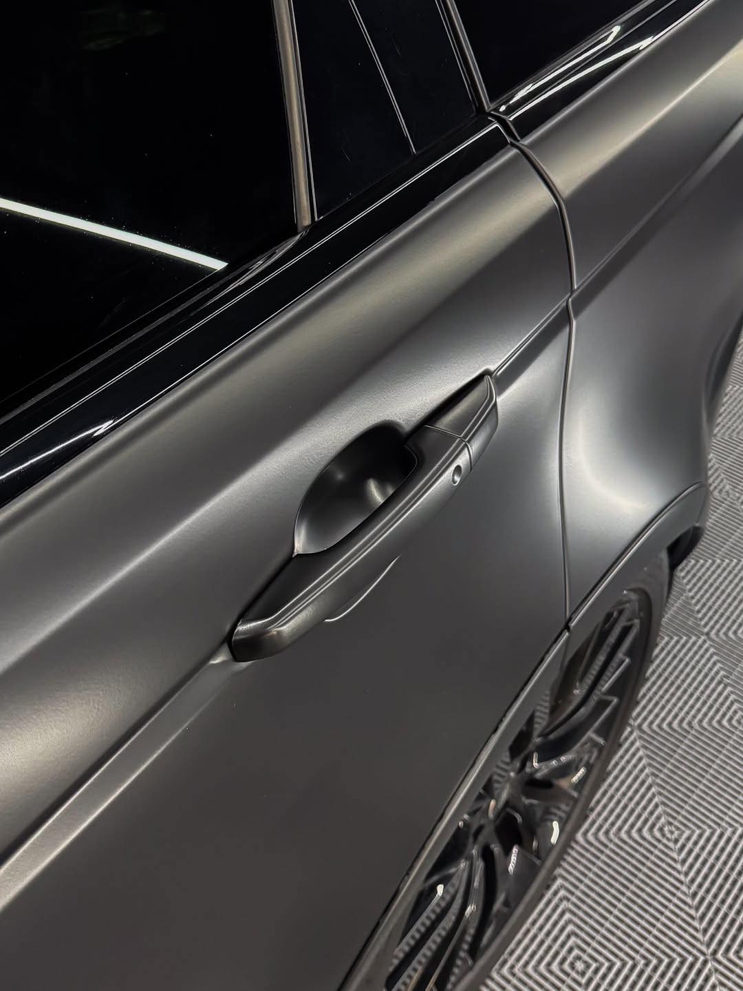 Close-up of a car door with Oracal Matte Black installed