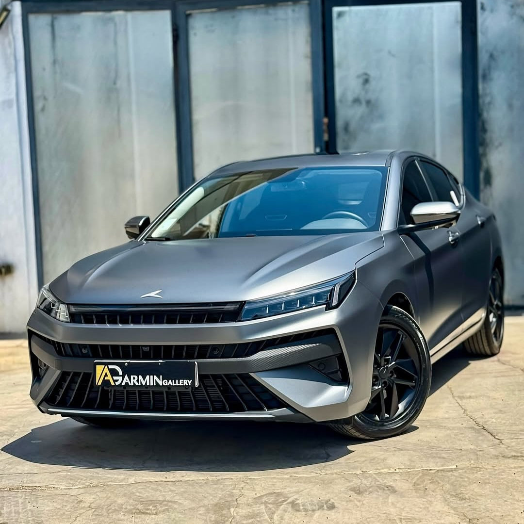 Oracal Matte Charcoal Metallic wrap installed on an SUV, which is parked in front of a glass building