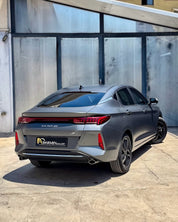 Oracal Matte Charcoal Metallic wrap installed on a car parked in front of a glass building