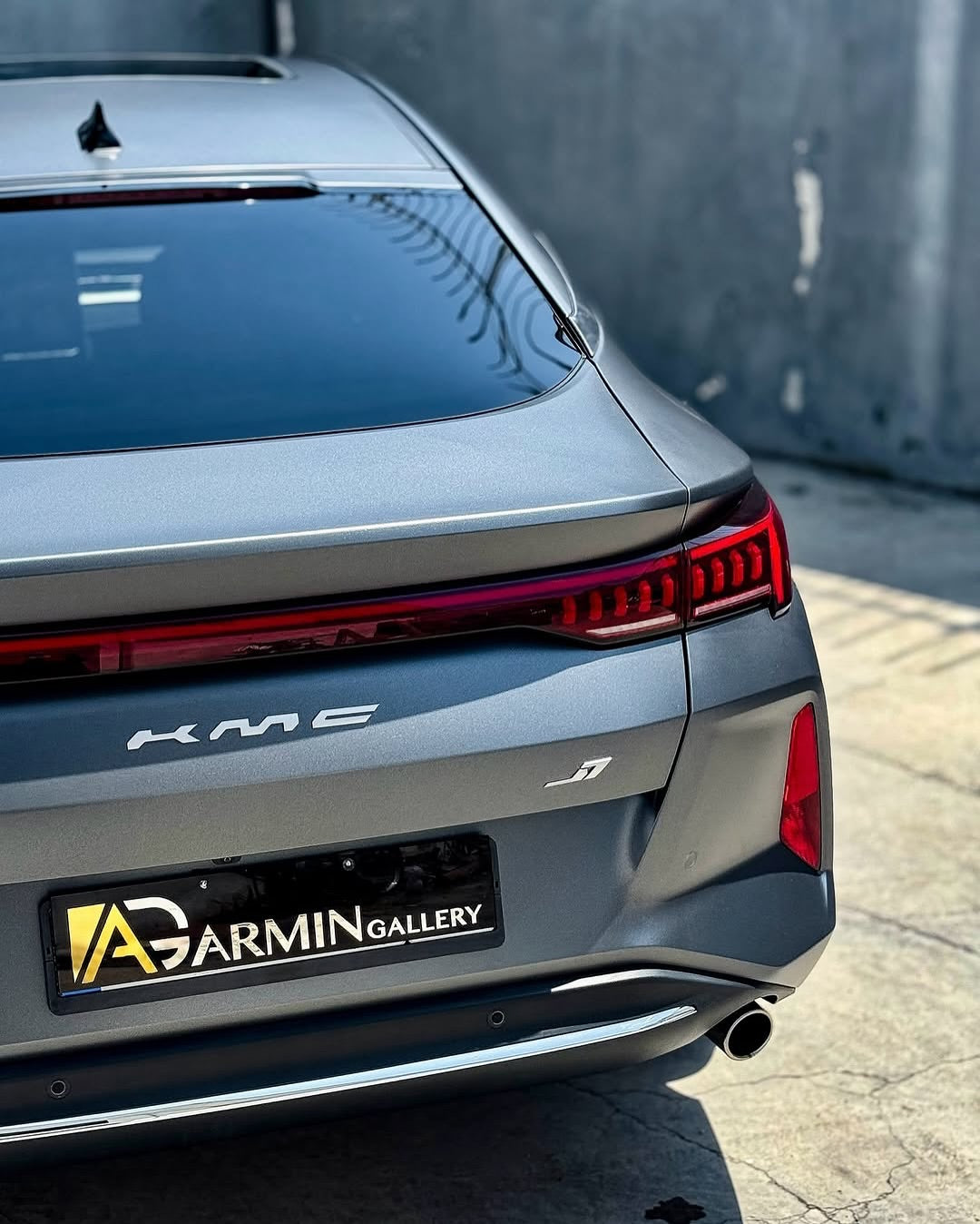 Back view of a car with Oracal Matte Charcoal Metallic wrap installed