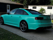 Oracal Matte Mint installed on Audi car parked on a driveway with a house and trees