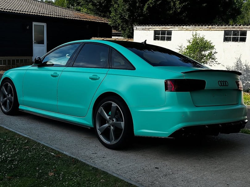 Oracal Matte Mint installed on Audi car parked on a driveway with a house and trees