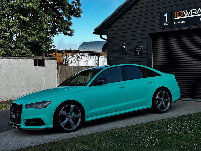 Oracal Matte Mint installed on Audi car parked in front of a building