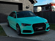 Oracal Matte Mint installed on Audi car parked in front of a wooden building
