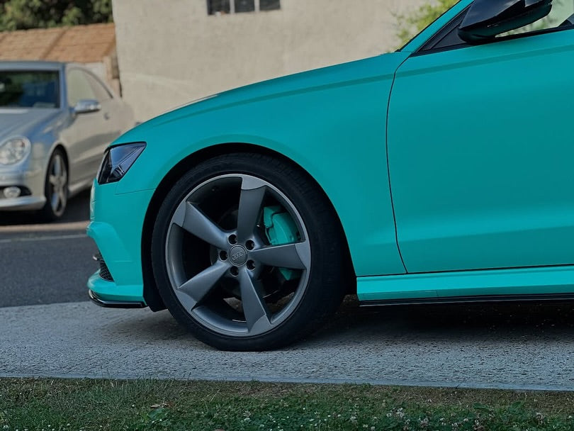 Close-up of an Oracal Matte Mint installed on a car parked on a street