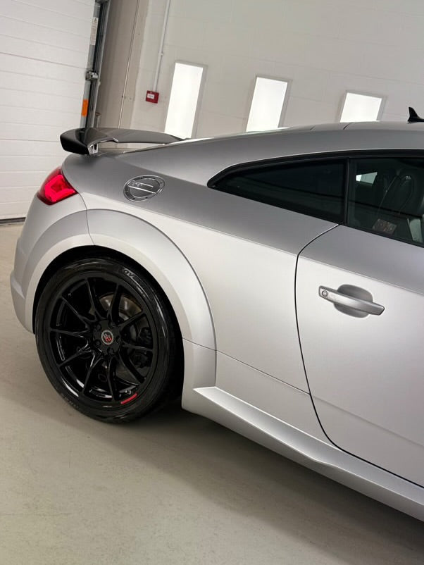 Oracal Matte Silver Grey Metallic installed on the Audi with black wheels in a garage