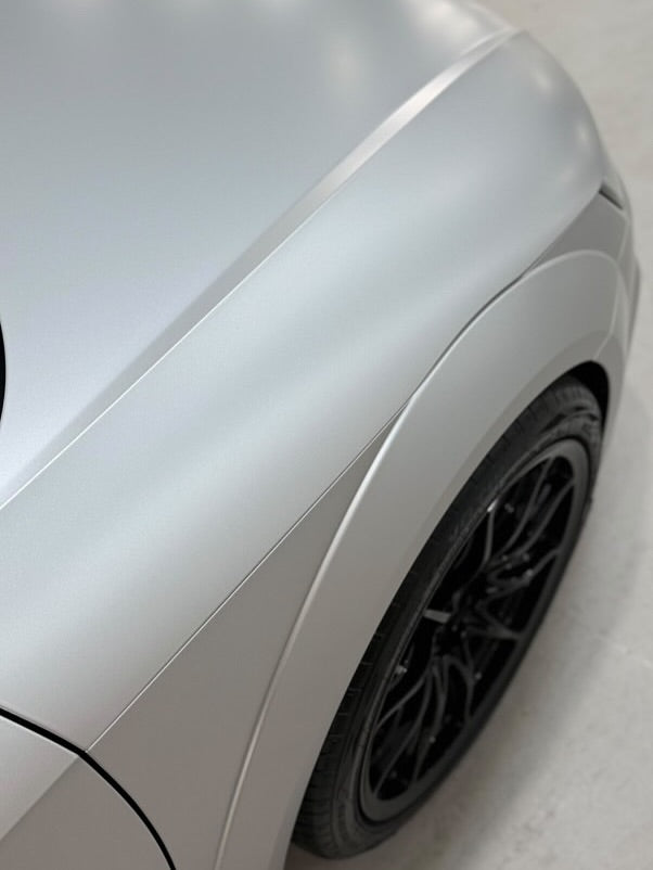 Oracal Matte Silver Grey Metallic installed on side profile with a focus on the wheel and tire